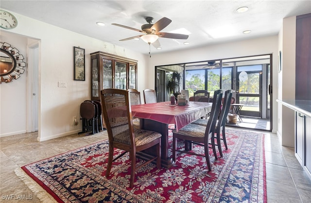 tiled dining area featuring ceiling fan