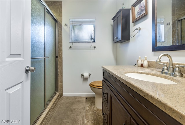 bathroom with tile patterned flooring, an enclosed shower, vanity, and toilet