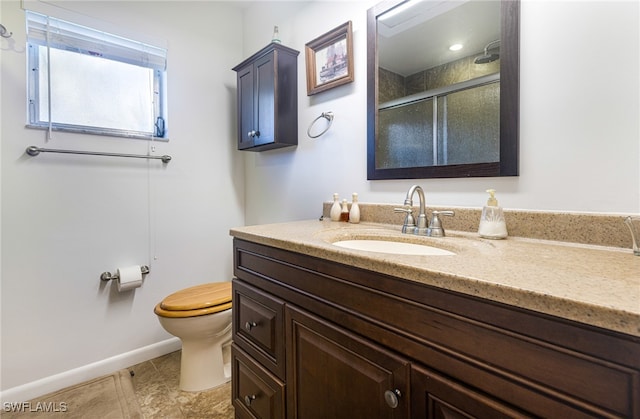 bathroom featuring toilet, vanity, an enclosed shower, and tile patterned flooring