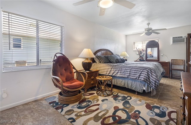 bedroom with a wall unit AC and ceiling fan