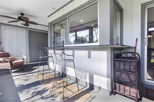 view of patio / terrace featuring ceiling fan and exterior bar