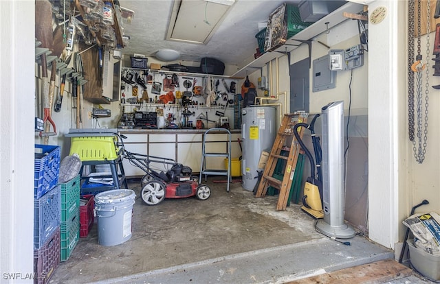 garage with a workshop area and electric water heater