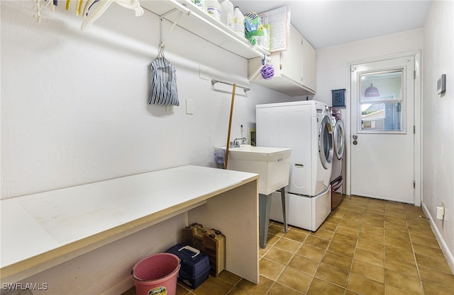 washroom with cabinets and washer and dryer