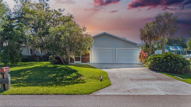 view of front facade with a garage and a yard