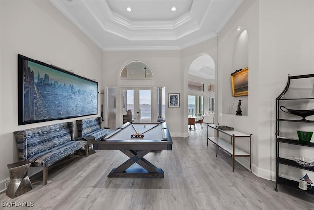 playroom with arched walkways, french doors, pool table, ornamental molding, and light wood-type flooring