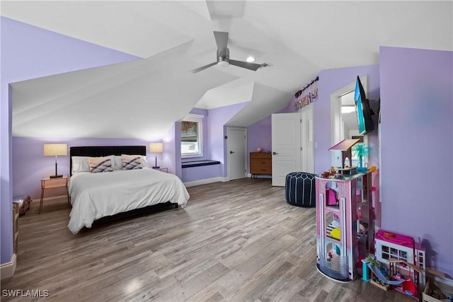 bedroom with vaulted ceiling, ceiling fan, wood finished floors, and baseboards