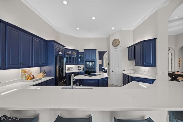 kitchen with light countertops, a peninsula, and a breakfast bar area