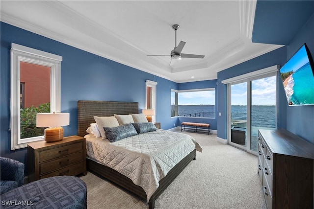 bedroom with light colored carpet, baseboards, access to exterior, ornamental molding, and a raised ceiling