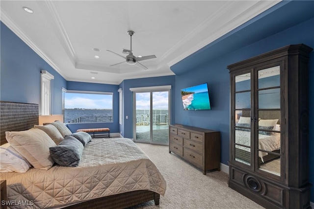 bedroom with baseboards, light colored carpet, access to exterior, a tray ceiling, and crown molding