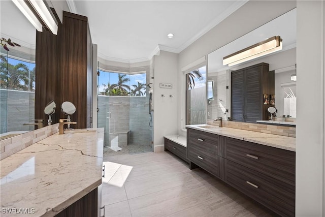 full bath featuring crown molding, vanity, and a shower stall