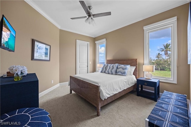 bedroom with carpet floors, crown molding, baseboards, and a ceiling fan