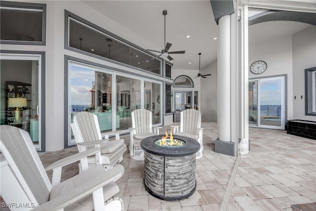 view of patio / terrace with ceiling fan and an outdoor fire pit