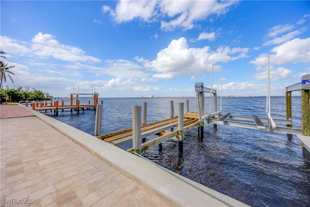 dock area with a water view and boat lift