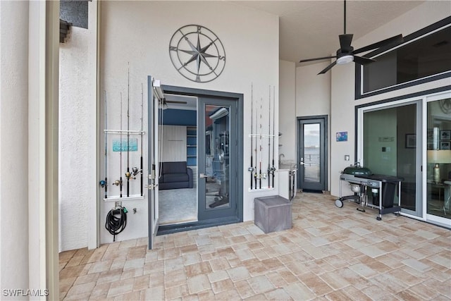 property entrance with ceiling fan