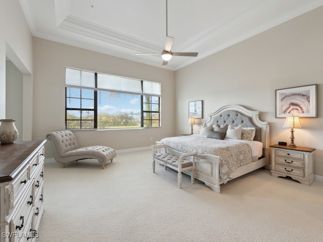 carpeted bedroom featuring ceiling fan, a raised ceiling, and ornamental molding