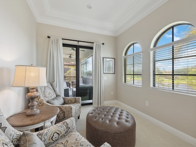 living area featuring carpet, a wealth of natural light, and ornamental molding