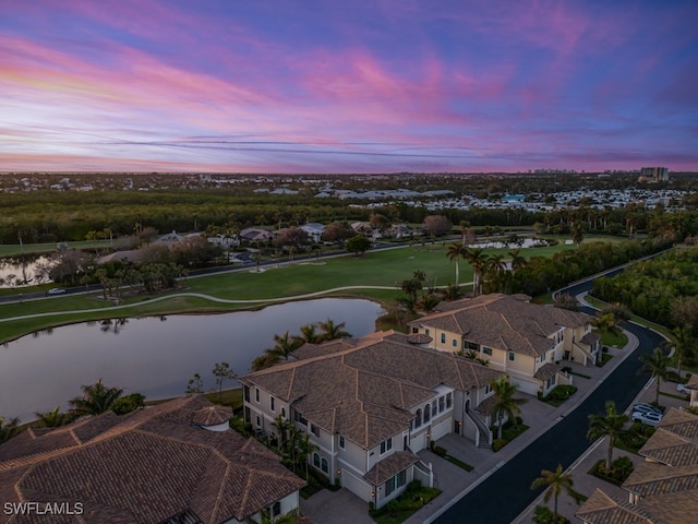 aerial view at dusk with a water view