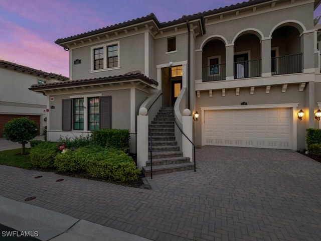 mediterranean / spanish-style home with a garage