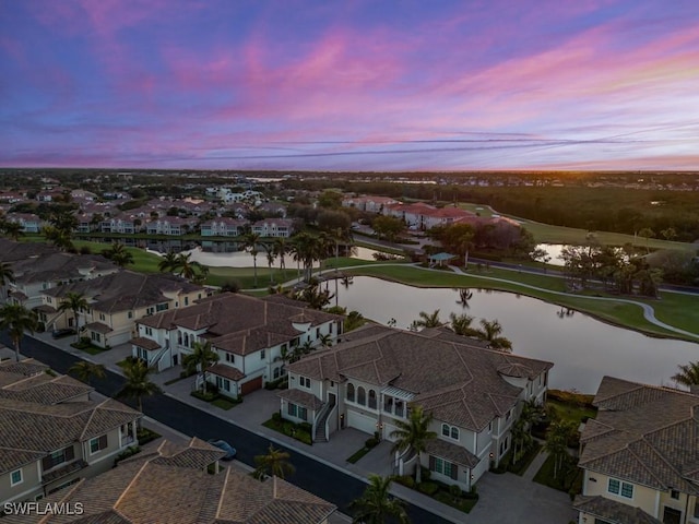 aerial view at dusk with a water view