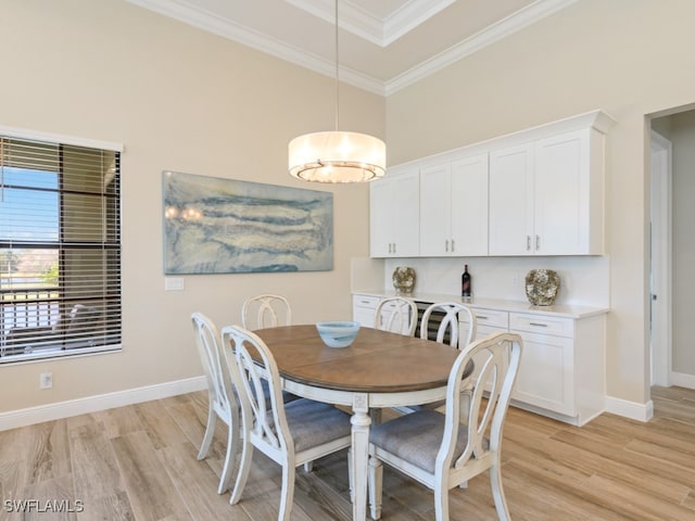 dining area featuring light hardwood / wood-style flooring and ornamental molding