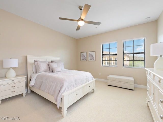 bedroom with ceiling fan and light carpet