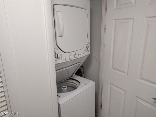 clothes washing area with stacked washer / drying machine and laundry area