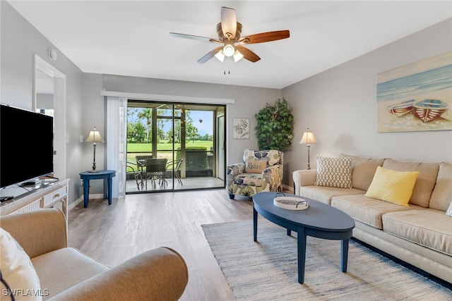 living room featuring light hardwood / wood-style floors and ceiling fan