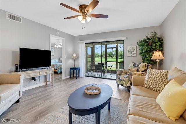 living room with hardwood / wood-style floors and ceiling fan