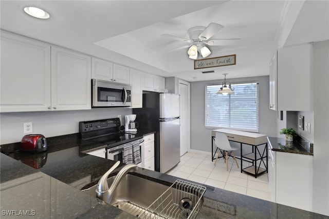 kitchen featuring stainless steel appliances, white cabinets, sink, light tile patterned floors, and ceiling fan