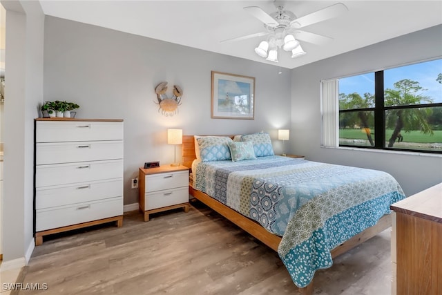 bedroom with hardwood / wood-style flooring and ceiling fan