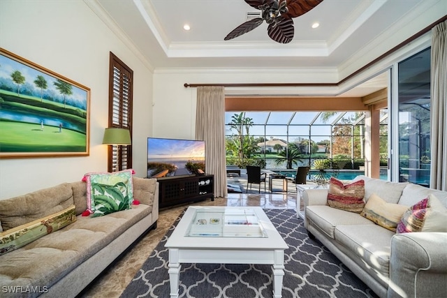 living room featuring ornamental molding, a raised ceiling, and ceiling fan