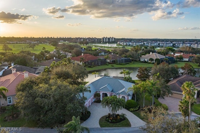 aerial view at dusk with a water view