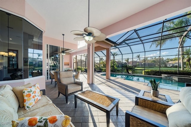 view of patio with a lanai, an outdoor living space, and ceiling fan