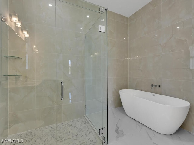 bathroom featuring tile walls and shower with separate bathtub