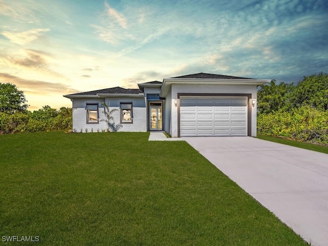 view of front of property with a lawn and a garage