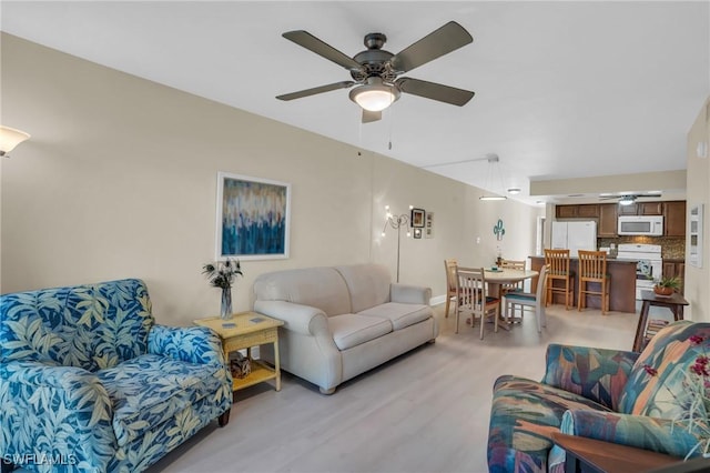 13663 Mcgregor Village Dr Unit 18, Fort Myers, FL 33919 - living room with a ceiling fan and light wood finished floors