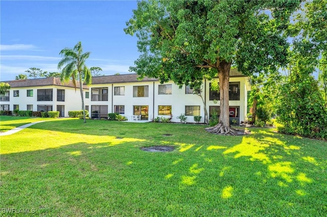 13663 Mcgregor Village Dr Unit 18, Fort Myers, FL 33919 - rear view of property featuring a lawn and stucco siding
