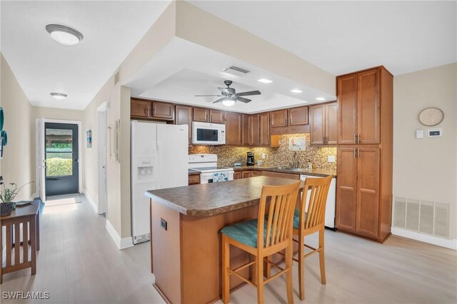 13663 Mcgregor Village Dr Unit 18, Fort Myers, FL 33919 - kitchen featuring white appliances, light wood-style floors, decorative backsplash, baseboards, and recessed lighting