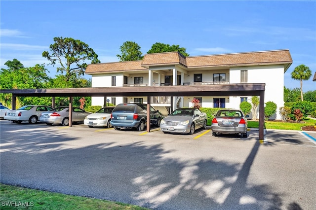 exterior space featuring a balcony and a carport