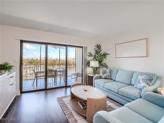 living area featuring baseboards and wood finished floors