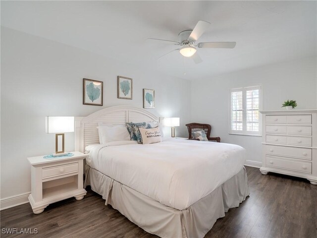 bedroom with ceiling fan and dark hardwood / wood-style floors