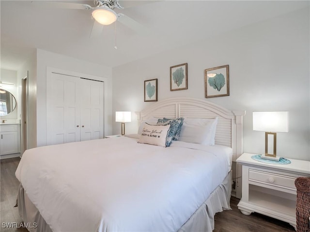 bedroom with dark wood-style floors, a closet, connected bathroom, and a ceiling fan