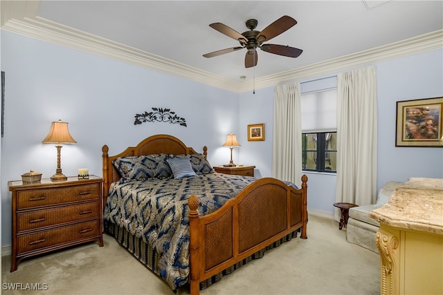 carpeted bedroom featuring ceiling fan and crown molding