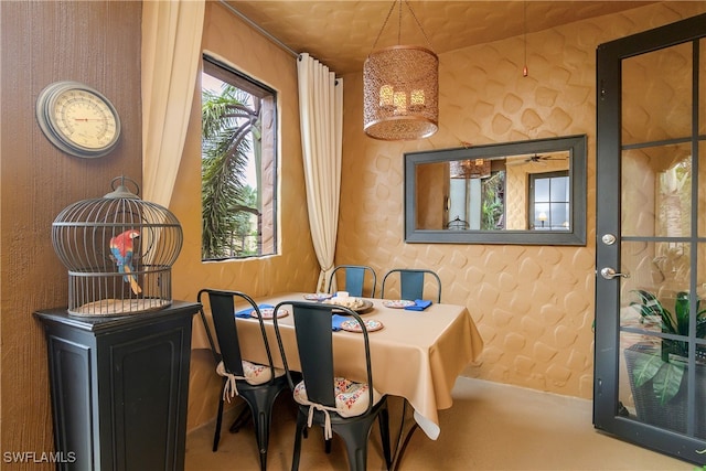 carpeted dining space with lofted ceiling