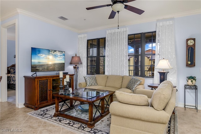 tiled living room with ceiling fan and crown molding