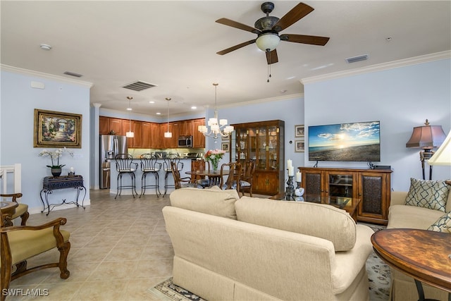 tiled living room featuring ceiling fan with notable chandelier and ornamental molding