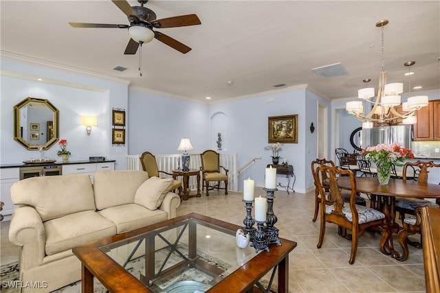 living room with light tile patterned floors, ceiling fan with notable chandelier, and ornamental molding