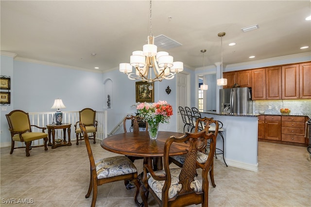 dining room with an inviting chandelier, ornamental molding, and light tile patterned flooring