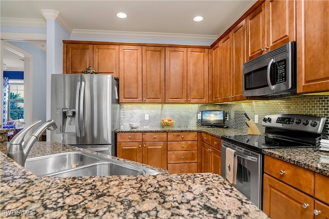 kitchen featuring sink, tasteful backsplash, dark stone countertops, appliances with stainless steel finishes, and ornamental molding