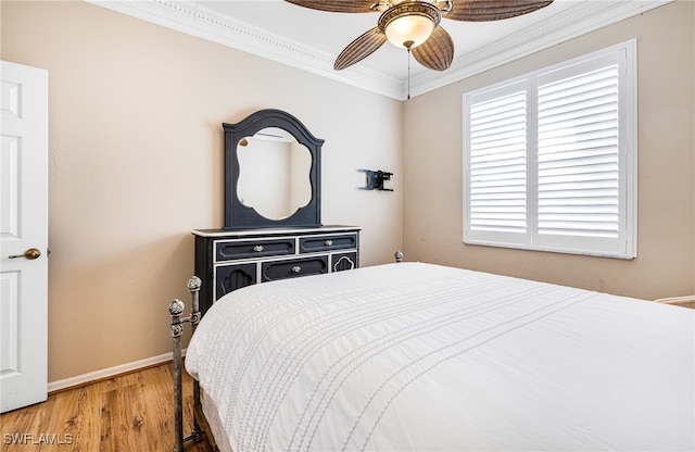 bedroom with ceiling fan, crown molding, and hardwood / wood-style flooring